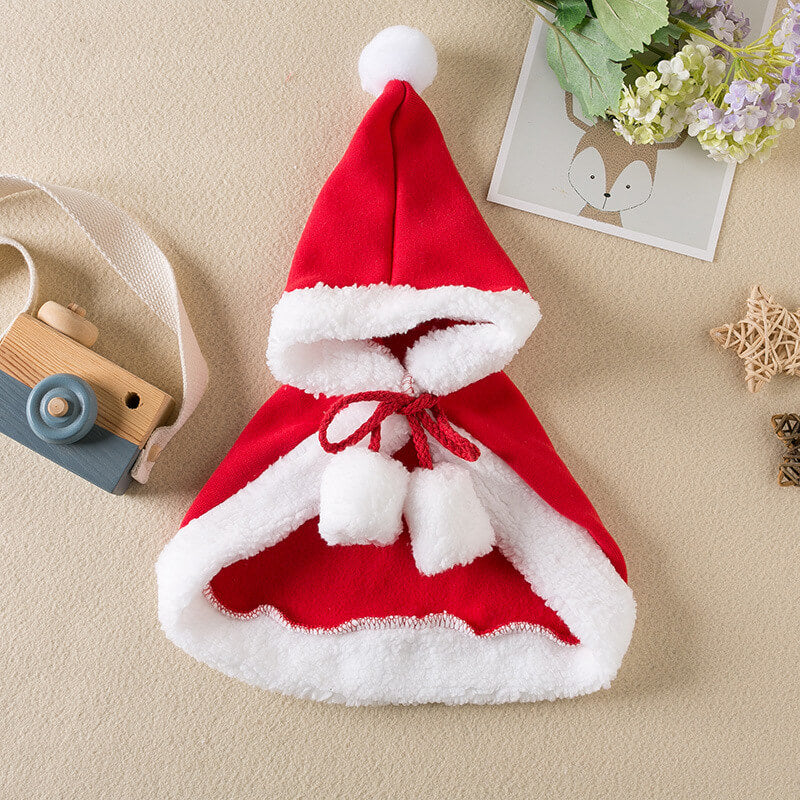 Red and white Santa hat with a bow on a beige surface