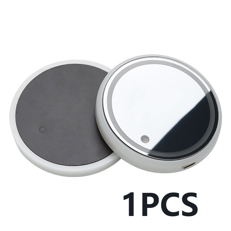 Round magnetic吸附器 with one black and one silver disc on a white background